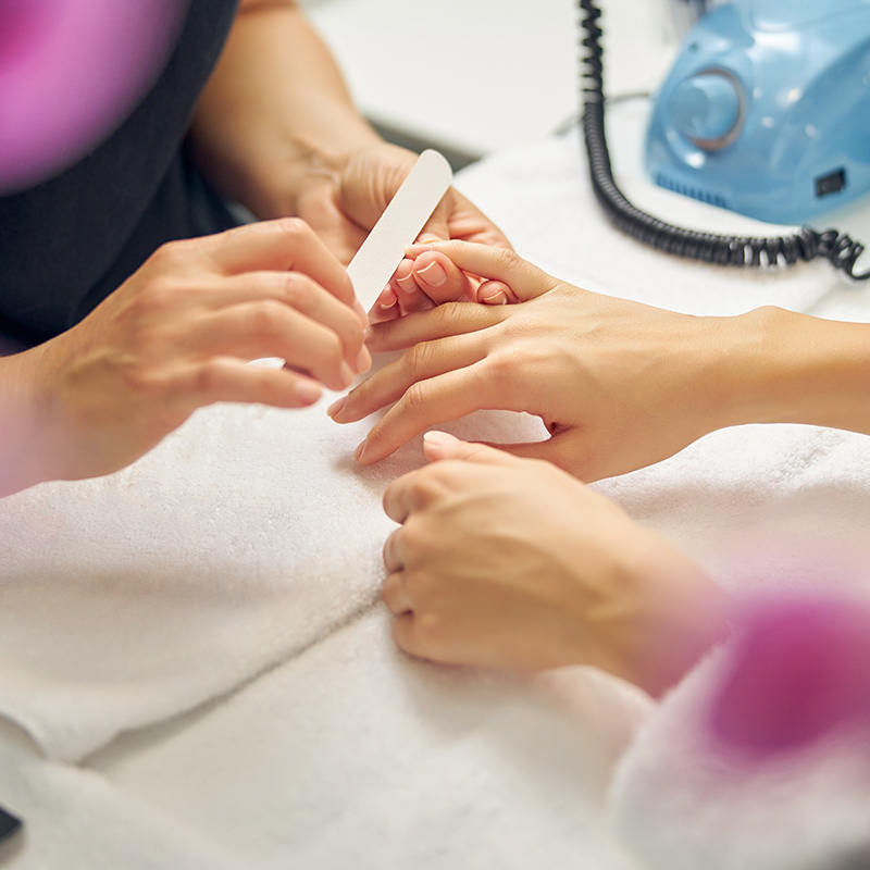manicurist working on a client's nails